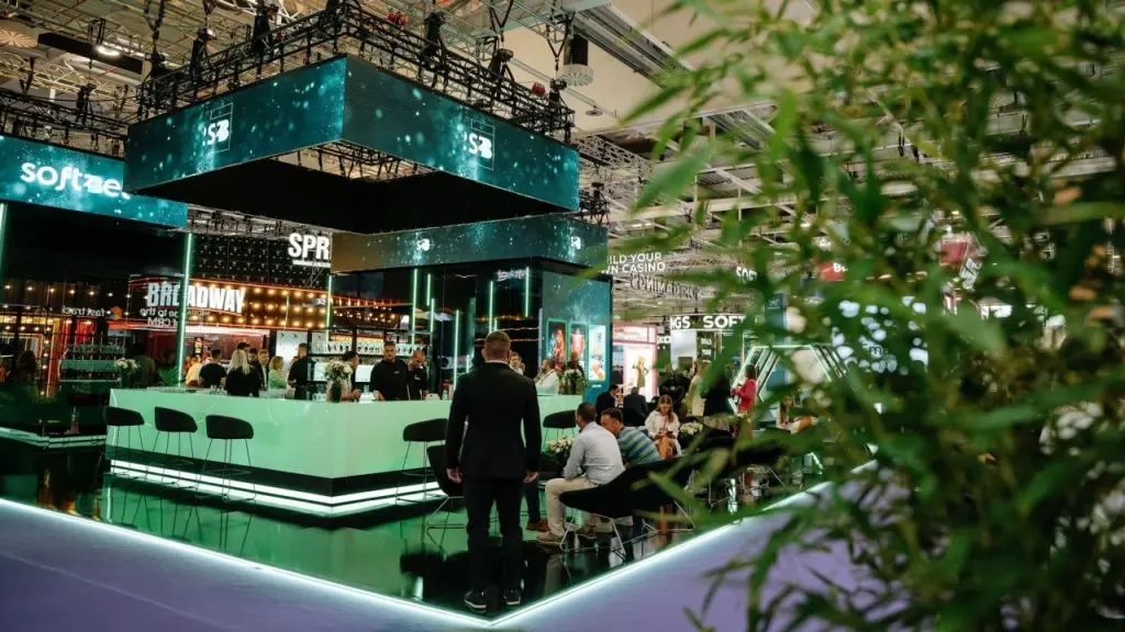 Modern exhibition stand with people discussing gaming solutions